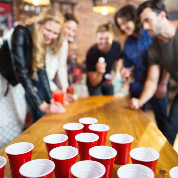 Drinking games during a Nice pub crawl with international travelers in a partner bar