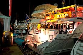 Party boat tour around Cannes with music dancing and the French Riviera coastline view